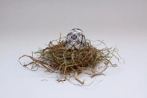 Traditional painted handmade Easter egg on hay Stock Photos