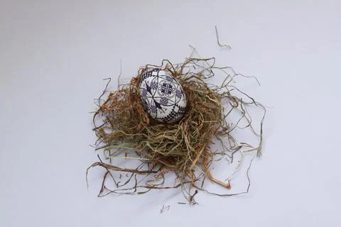 Traditional painted handmade Easter egg on hay Stock Photos