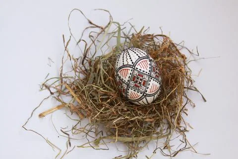 Traditional painted handmade Easter egg on hay Stock Photos