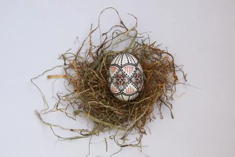 Traditional painted handmade Easter egg on hay Stock Photos