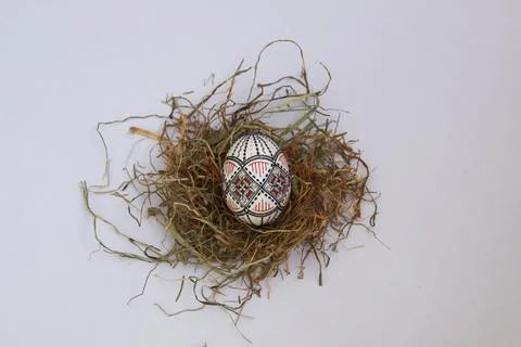 Traditional painted handmade Easter egg on hay Stock Photos