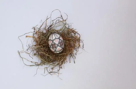 Traditional painted handmade Easter egg on hay Stock Photos