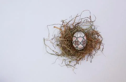 Traditional painted handmade Easter egg on hay Stock Photos