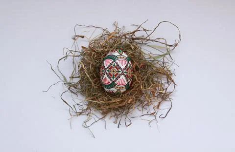 Traditional painted handmade Easter egg on hay Stock Photos
