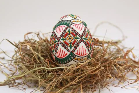 Traditional painted handmade Easter egg on hay Stock Photos