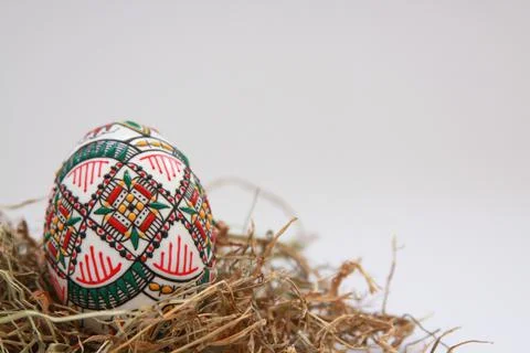 Traditional painted handmade Easter egg on hay Stock Photos