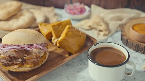 Traditional Peruvian Breakfast with Chicharron Pork Sandwich Tamale and Coffee Video stock 339077993