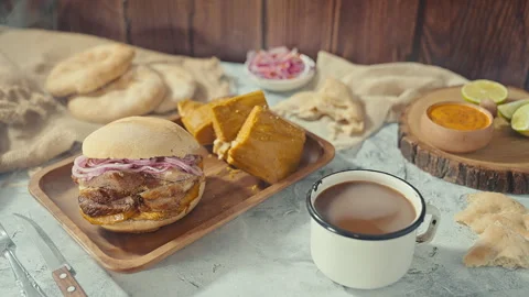 Traditional Peruvian Breakfast with Chicharron Pork Sandwich and Tamale Stock Footage 341439678