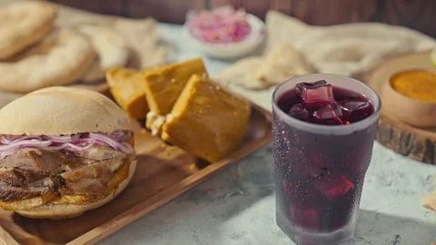 Traditional Peruvian Breakfast with Chicharron Pork Sandwich and Tamale Stock Footage 341439700
