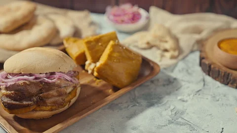 Traditional Peruvian Breakfast with Chicharron Pork Sandwich and Tamale Vídeo Stock 344985718
