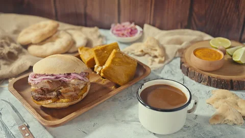 Traditional Peruvian Breakfast with Chicharron Pork Sandwich and Tamale 動画素材 344985736