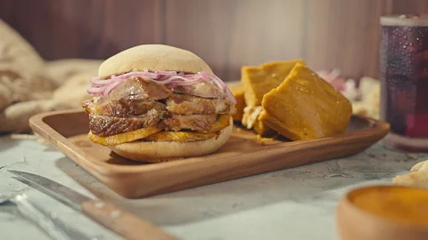 Traditional Peruvian Breakfast with Chicharron Pork Sandwich and Tamale 動画素材 344985895