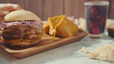 Traditional Peruvian Breakfast with Chicharron Pork Sandwich and Tamale Vídeo Stock 344985906