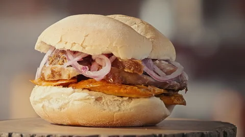 Traditional Peruvian Pan con Chicharron Pork Sandwich with Sweet Potato Stock Footage 338341366