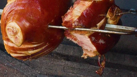 Traditional Pork Knuckle Roasting on Spit Over Wood Fire Stock Footage 321379804