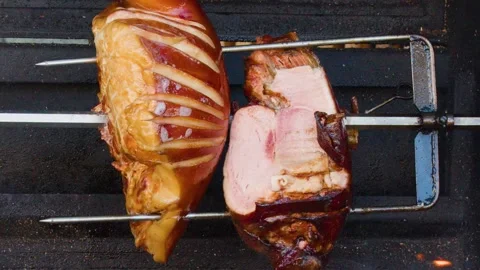 Traditional Pork Knuckle Rotating on Spit Over Open Wood Fire Stock Footage 321663937