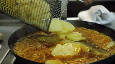 Traditional portuguese dish - fried codfish with onion. Stock Footage 63395445