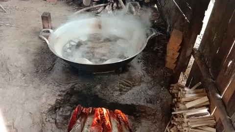 Traditional process of making palm sugar, cooking raw palm extract on traditi Stock-Footage 142135959