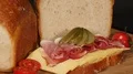 traditional raisin bread with ham and cheese on turntable close 4k or 4k+ Resolution