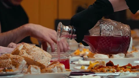 Traditional Ramadan Dinner with Bread and Drink Being Poured Stock Footage 339111306