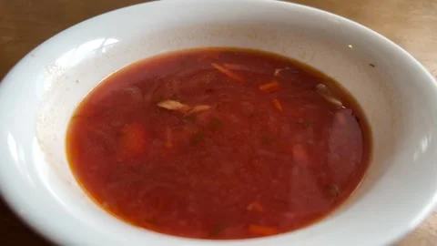 Traditional red borscht with beetroot and shredded vegetables served Video stock 346516036