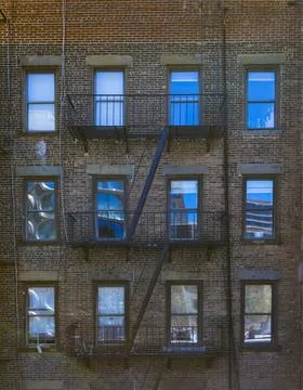 Traditional Red Brick Facade with Fire Escape, New York City Stock Photos