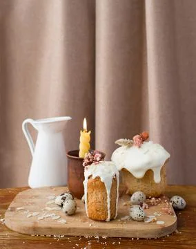 Traditional Russian Easter cake with icing and candle quail eggs on a wooden  Stock Photos
