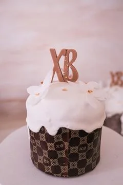 Traditional Russian Easter kulich cake topped with sugar icing and XB sign. Stock Photos