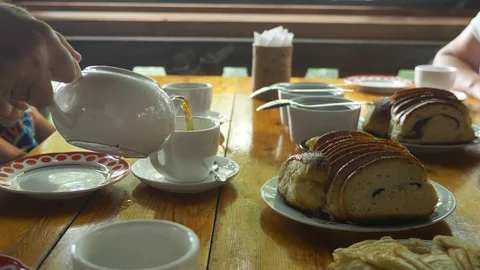 Traditional russian tea party. a table served with tea cups, teapots, on the Stock Footage 116573228