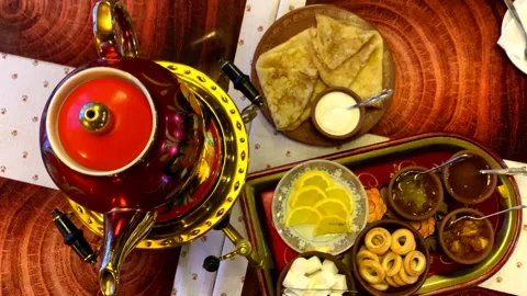 Traditional Russian tea. plate samovar pancakes lemon sour creme top view Stock Footage 167429459