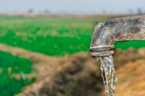 A traditional rusty hand pump to control drinking water crisis Stock Photos