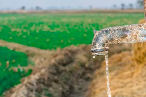 A traditional rusty hand pump to control drinking water crisis Stock Photos