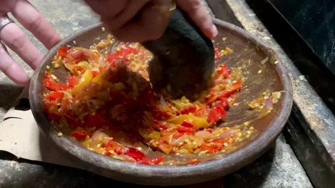 Traditional Sambal Preparation Using Stone Mortar Stock Footage 325549749