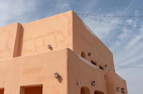Traditional Sand-Colored Building with String Lights at Mina District. Фото