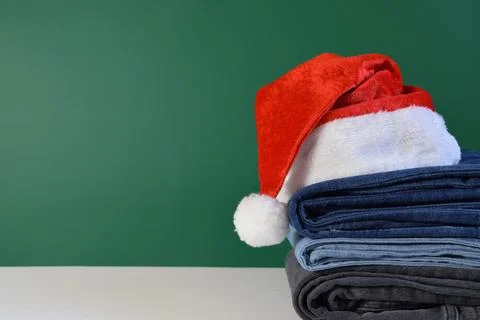 A traditional Santa Claus hat on a stack of jeans Stockfoto's