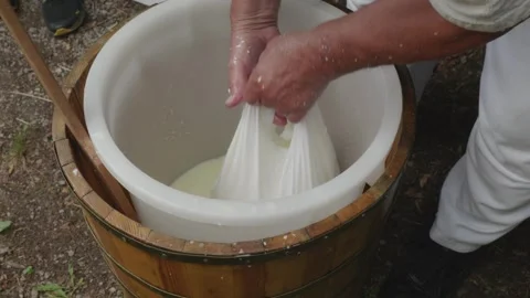 Traditional Sheep Cheese Making – Tying Cheese in White Cloth Stock Footage 314552050
