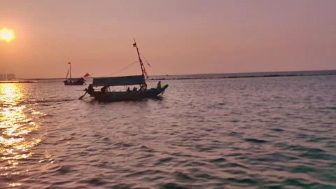 Traditional ships pass over the vast ocean at sunset. Stock Footage 338418897
