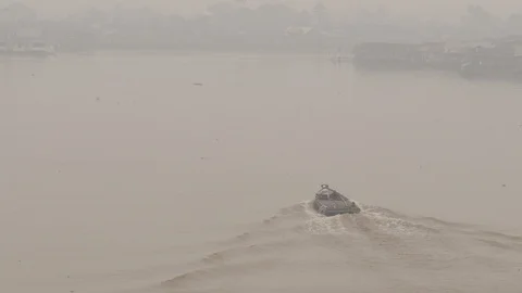 Traditional small cargo ship passing through the river that covered by smoke Stock Footage 121648937