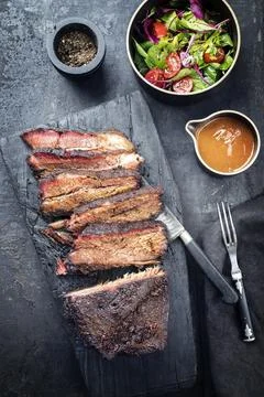 Traditional smoked barbecue wagyu beef brisket offered as top view on an old  Stock Photos