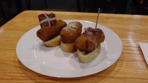 Traditional Spanish Basque snack called Pintxo with fish, cheese, and ham Stock Footage 291987521