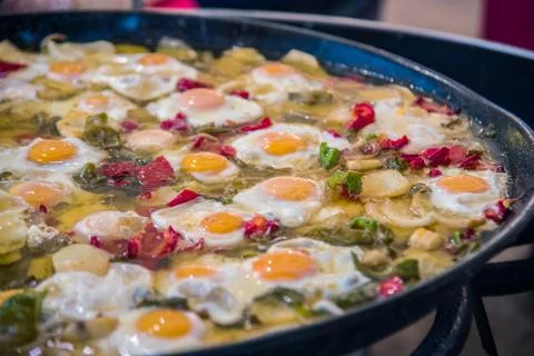 Traditional spanish big pan of fried eggs, paprika, dried tomatoes and parsle Stock Photos