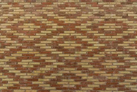 Traditional Spanish brick wall pattern, background, and texture. Stock Photos