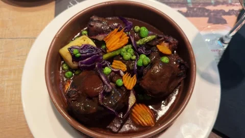 Traditional Spanish oxtail stew with potato, cooked meat in red wine sauce in Stock Footage 303505341