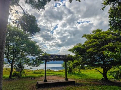 Traditional Stone Gate Structure Overlocking Scenic Mountain Lake and Cloudy Sky Stock Photos