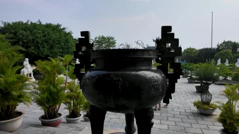 Traditional stone incense burner on three legs courtyard of Linh Ung Pagoda in Stock Footage 346859948
