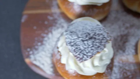 Traditional Swedish Semla served on rustic cutting board Stock Footage 102905090