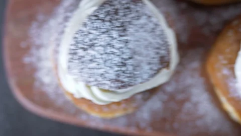 Traditional Swedish Semla served on rustic cutting board Stock Footage 102905143