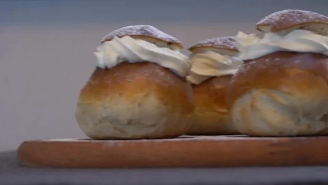 Traditional Swedish Semla served on rustic cutting board 스톡 동영상 102905189