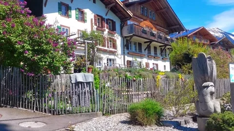 Traditional Swiss Chalet Surrounded by Spring Flowers, Brienz 4K Stock Footage 341279631