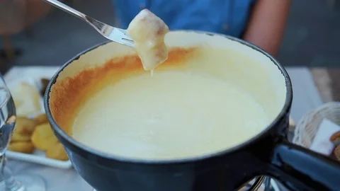 A traditional Swiss food: the fondue cheese. Slowmotion Stock Footage